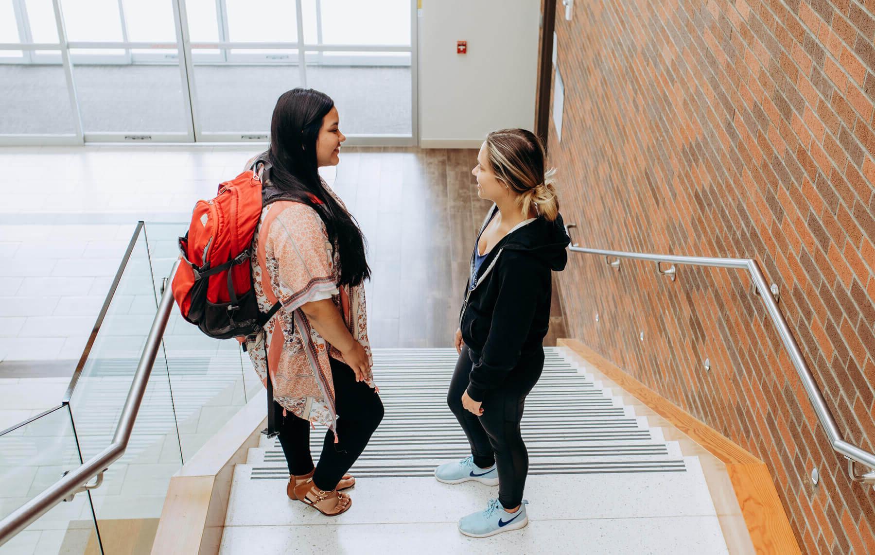 Two students talking on their way to class